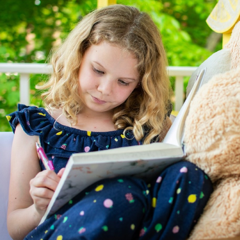How to Tell Whether You're a Writer little girl writing in a book