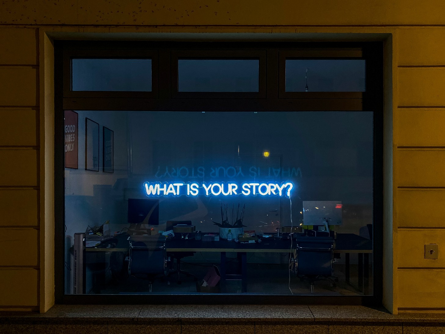 Neon lighting with text: "What is your story?"
