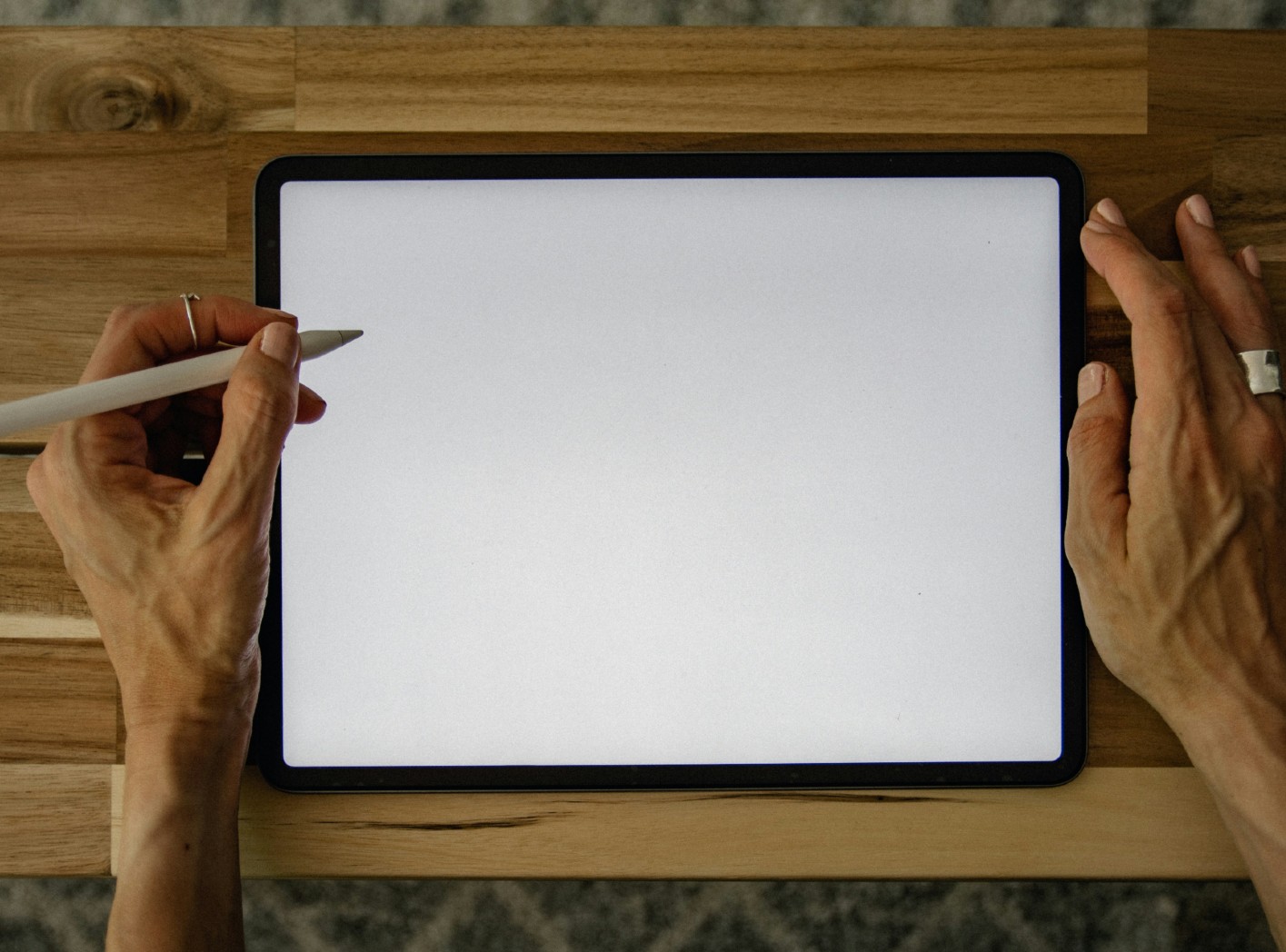 Blank screen with hand and stylus for writing a memoir's first sentence