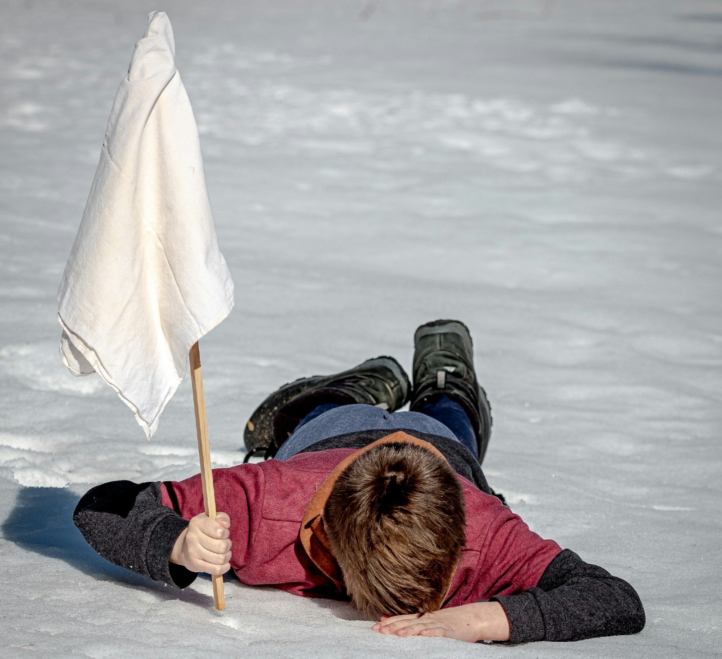 Person planting white flag to show surrendering