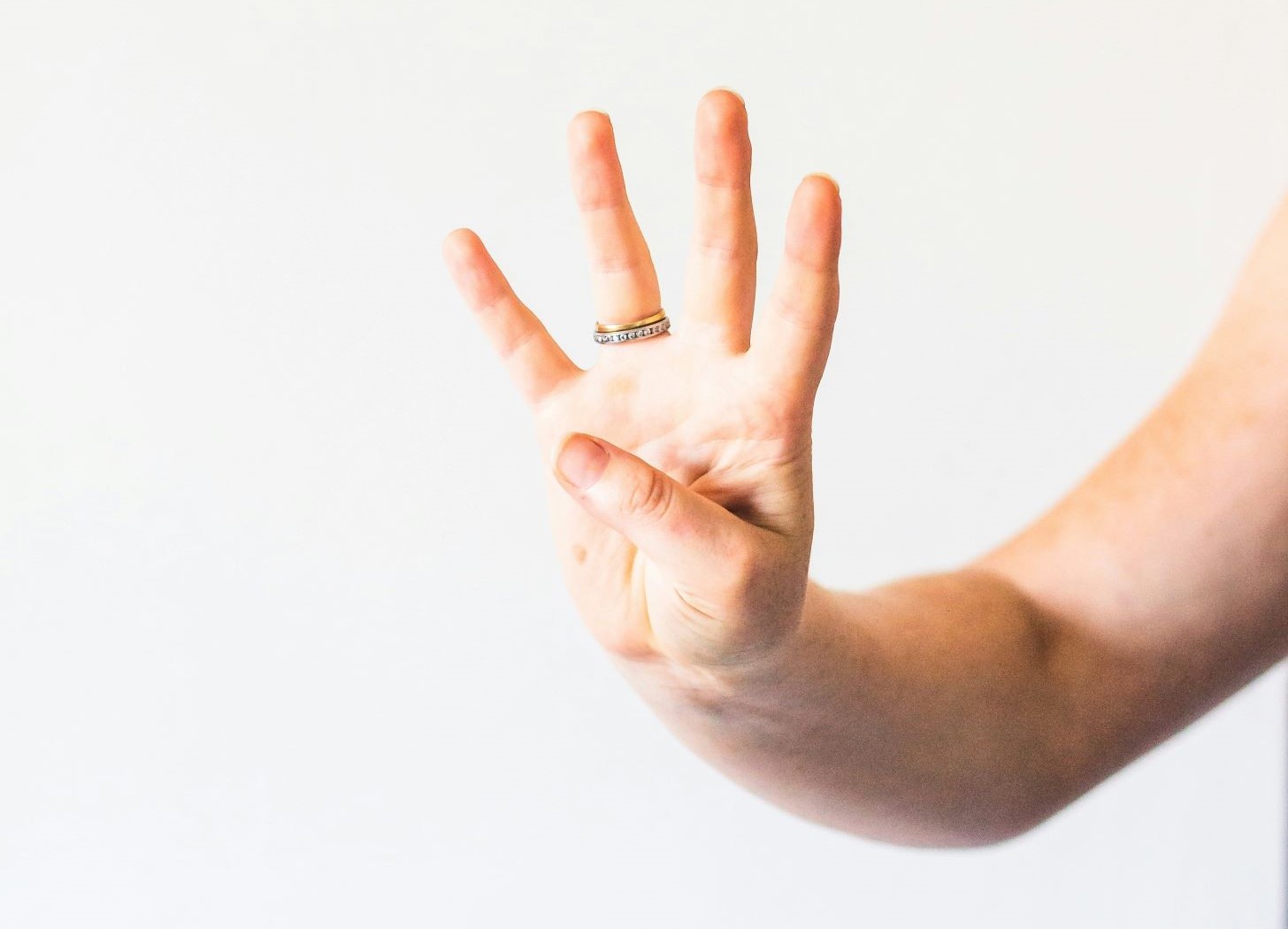 Hand showing four fingers raised