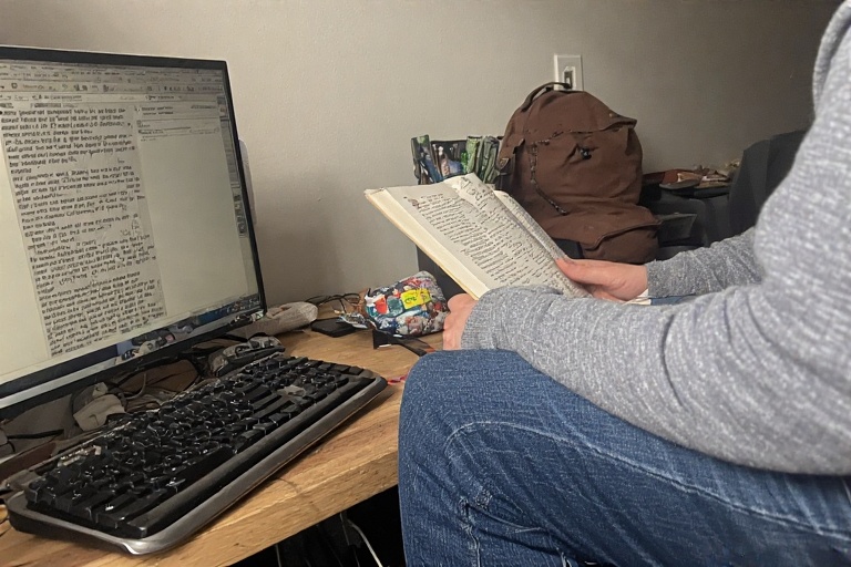 Someone reading notes while sitting at the computer